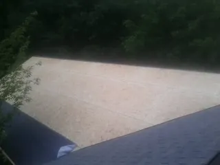 New OSB roof sheathing installed beside an existing shingle roof in Fort Hill