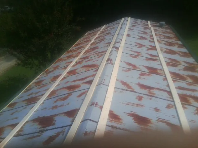 Rusted metal roof panels with new wood purlins before replacement — Storm Damage Roof Repair in Fort Hill by Roofing Brothers